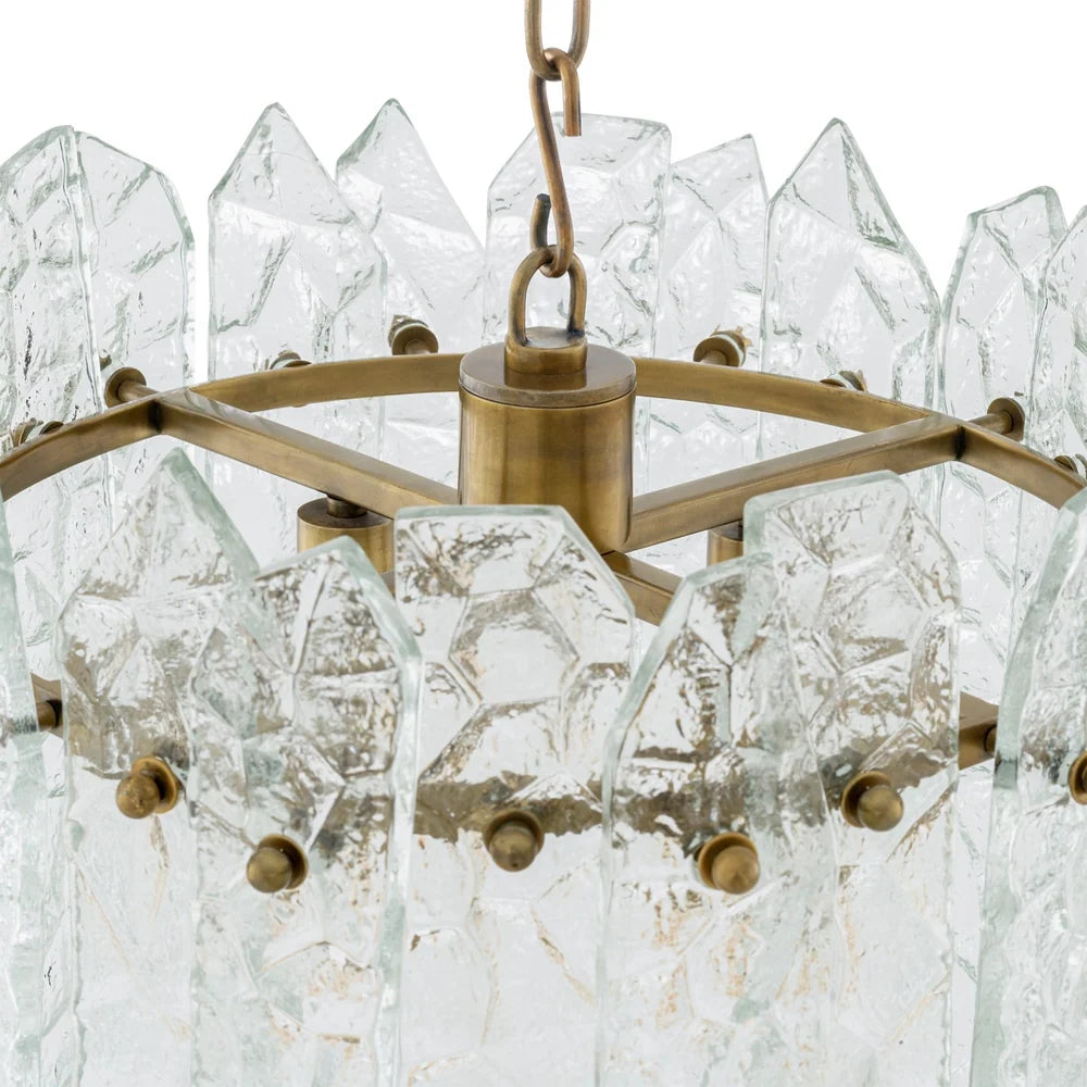 Elegant Prati Chandelier featuring a sophisticated vintage brass finish and sculptural glass construction.
