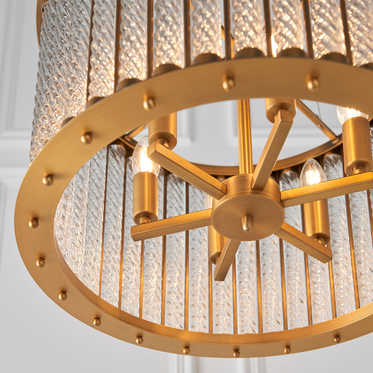 remium detail showcasing the intricate relationship between gold metalwork and clear glass