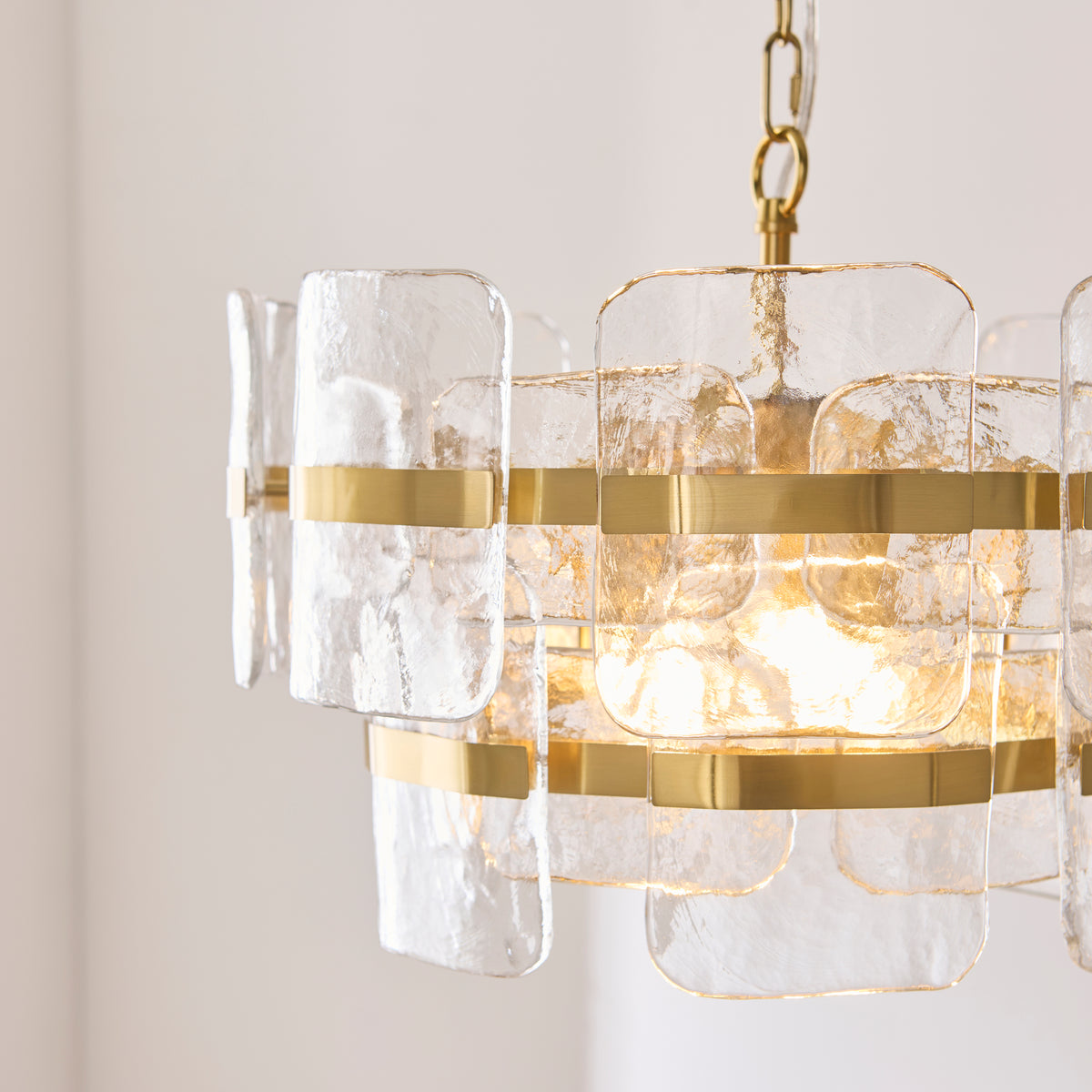 Premium close-up highlighting the combination of textured glass and aged brass plated detailing