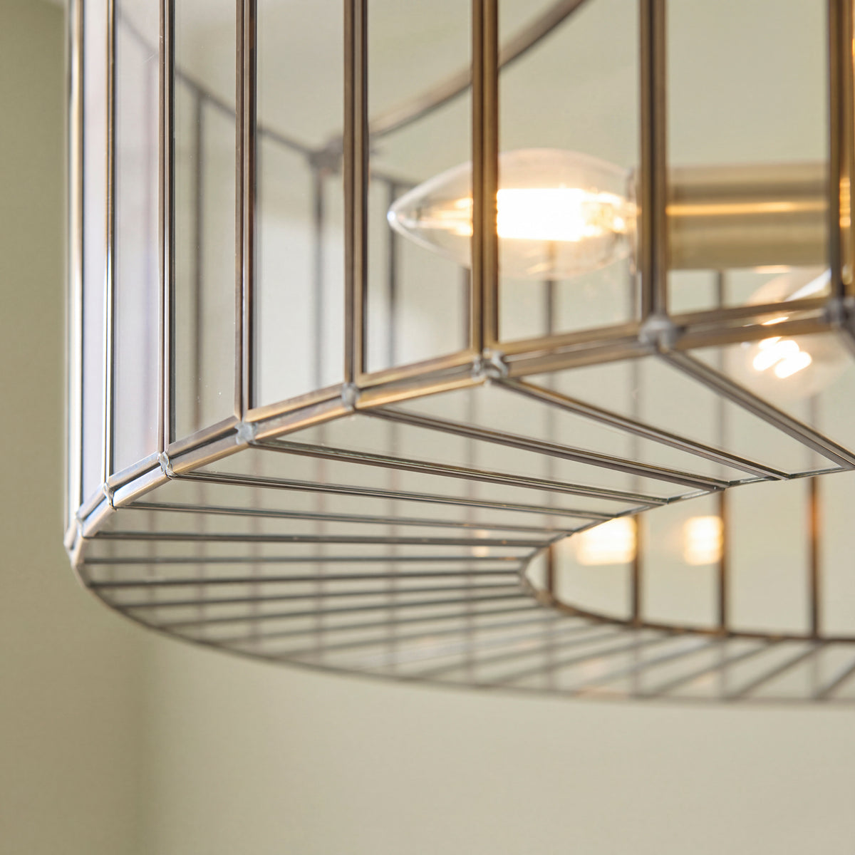 Detailed view of the clear glass inserts within the pendant frame