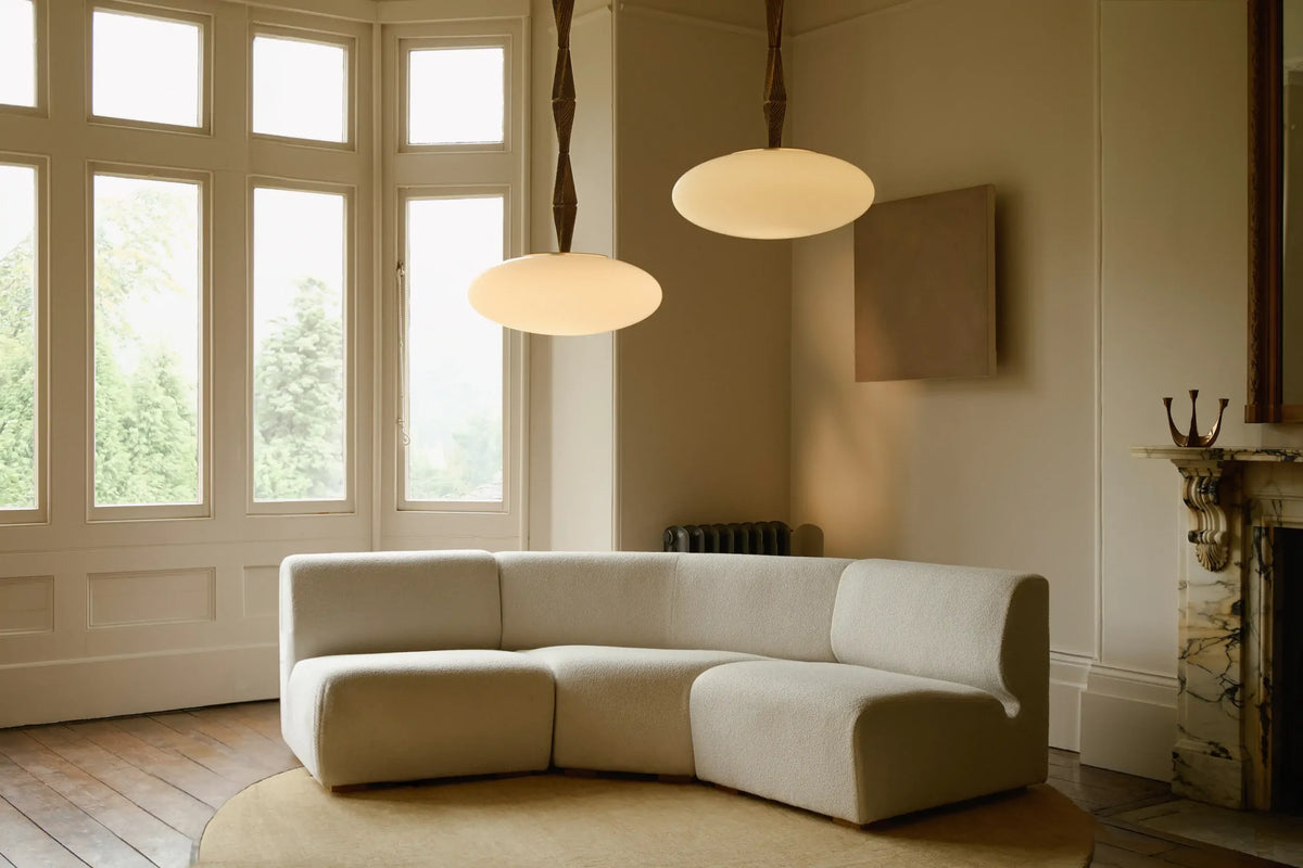 Elegant Jules Pendant with refined cast bronze detailing and luminous matt opal glass