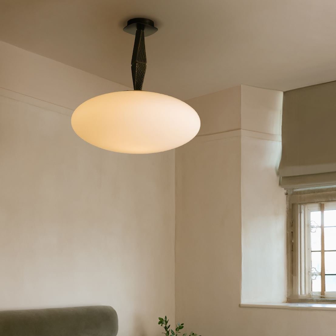 Jules Pendant showcasing sculptural cast bronze elements and softly diffused matt opal glass