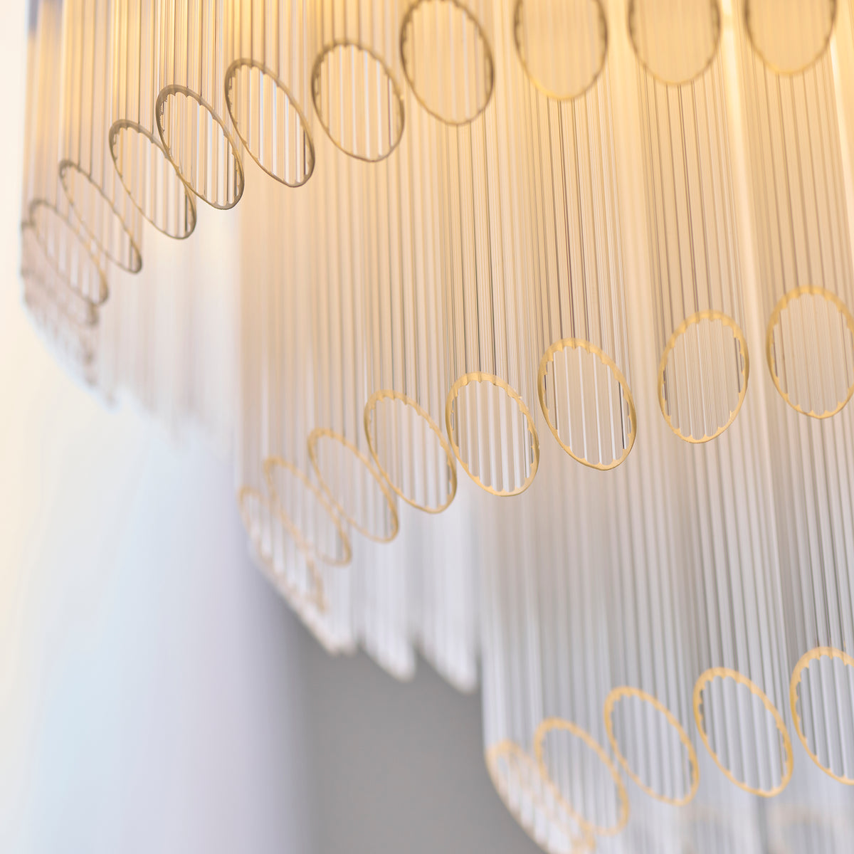 Close-up revealing the layered tubular glass chandelier design