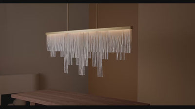 Cascata Long featuring delicate clear wavy kiln glass with a sculptural cascading effect