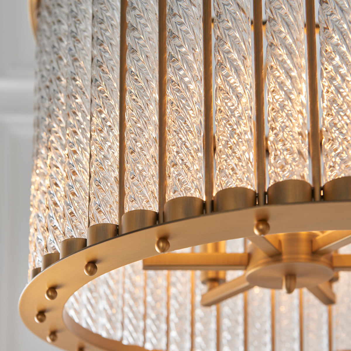 Side perspective highlighting the layered glass columns surrounding the chandelier structure