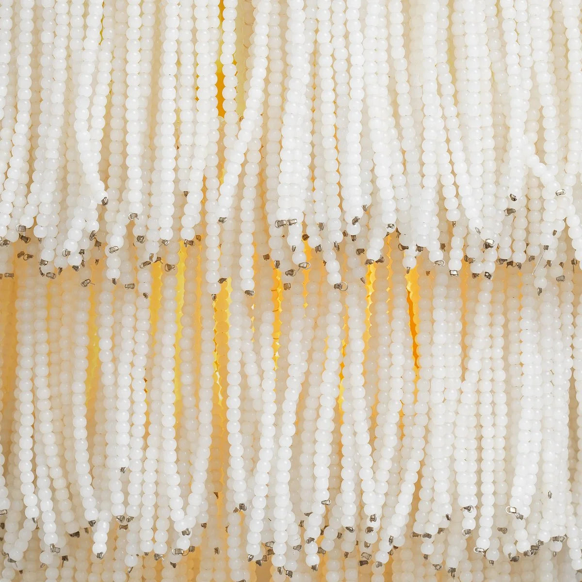 Rosaline Wall Lamp illuminated to reveal a soft and atmospheric glow through its delicate glass beads.