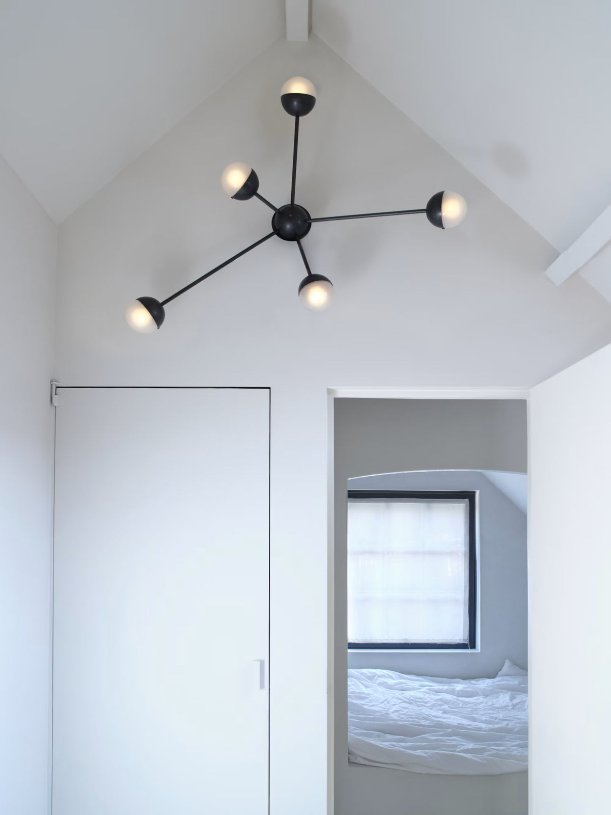 Radial composition of the Schwung Molecule Spark Wall Sconce