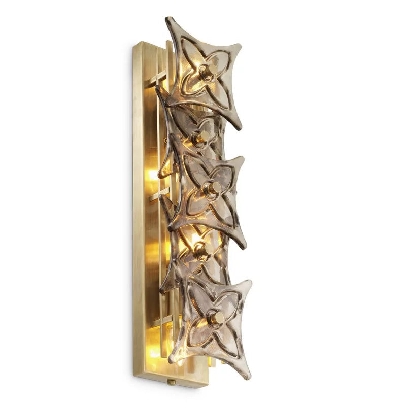 Silvaris Wall Lamp illuminated, creating a warm and atmospheric glow through sculptural smoke glass